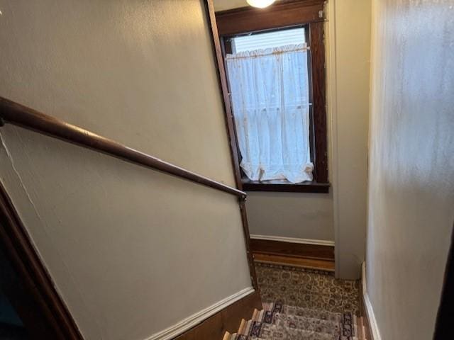 stairway featuring baseboards