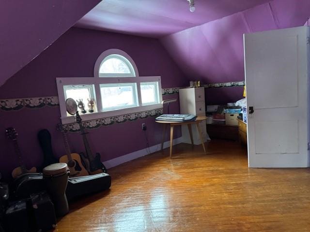 bonus room with vaulted ceiling and wood finished floors