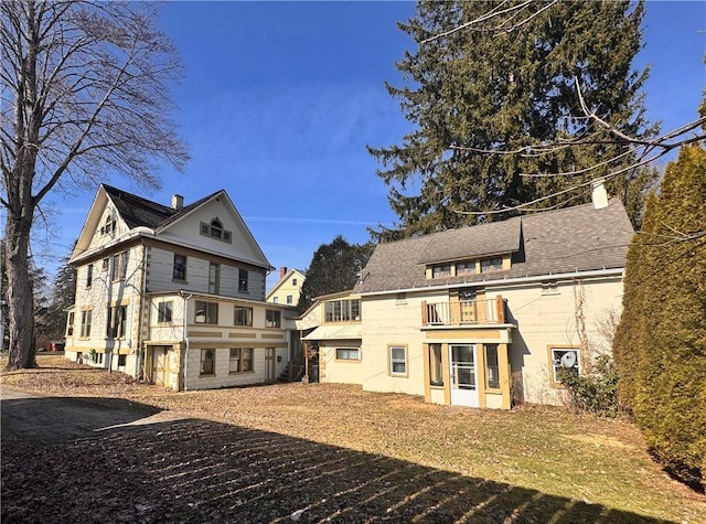 back of property featuring a balcony