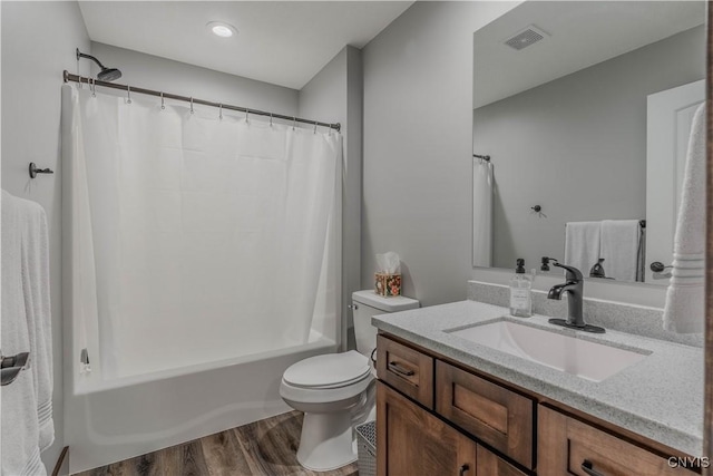 full bathroom featuring shower / bath combo with shower curtain, vanity, wood-type flooring, and toilet