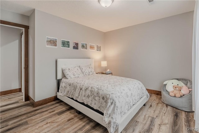 bedroom with hardwood / wood-style floors