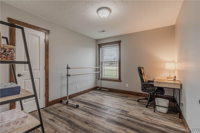 office space with hardwood / wood-style floors and a textured ceiling