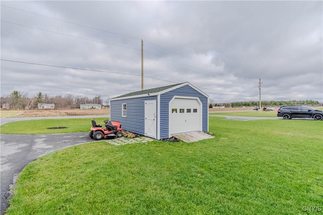 garage featuring a lawn