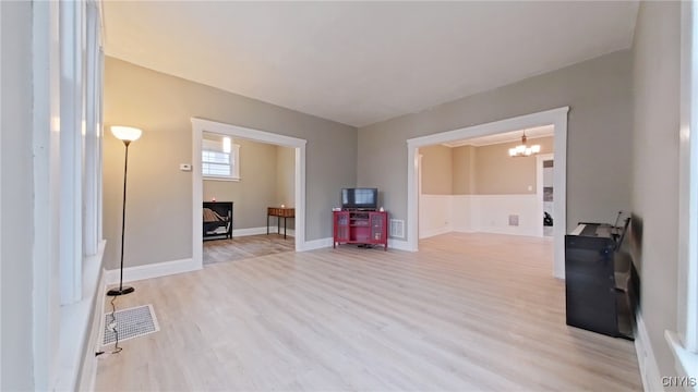 interior space with a chandelier and light wood-type flooring