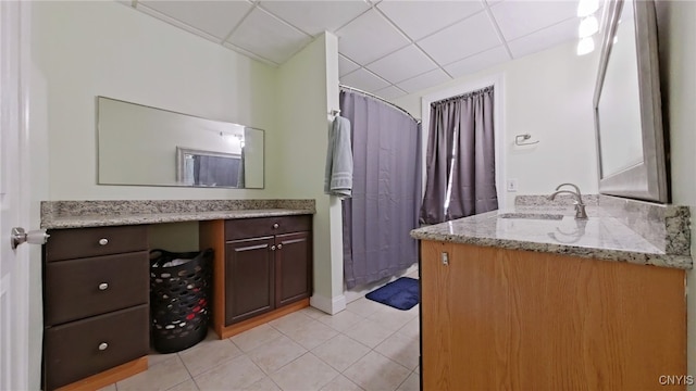 bathroom featuring a shower with curtain, vanity, tile patterned floors, and a drop ceiling