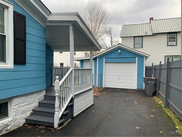 exterior space featuring a garage and an outdoor structure