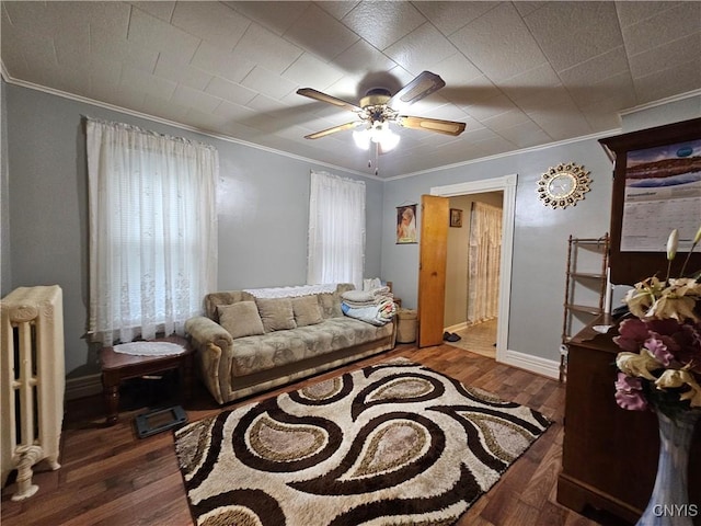 living room with dark hardwood / wood-style floors, radiator heating unit, and ornamental molding