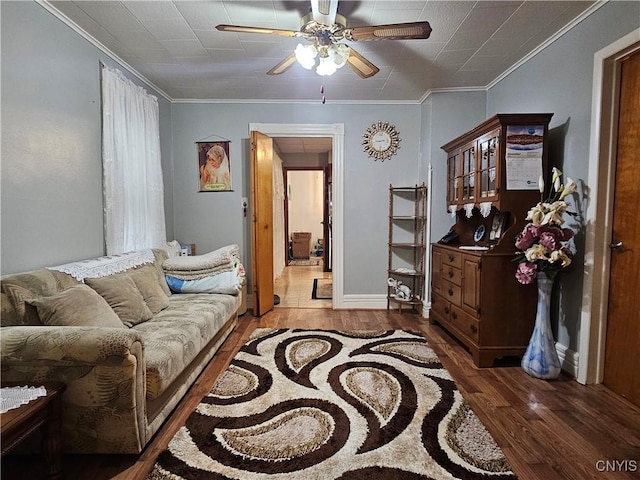 living room featuring ceiling fan, dark hardwood / wood-style flooring, and ornamental molding