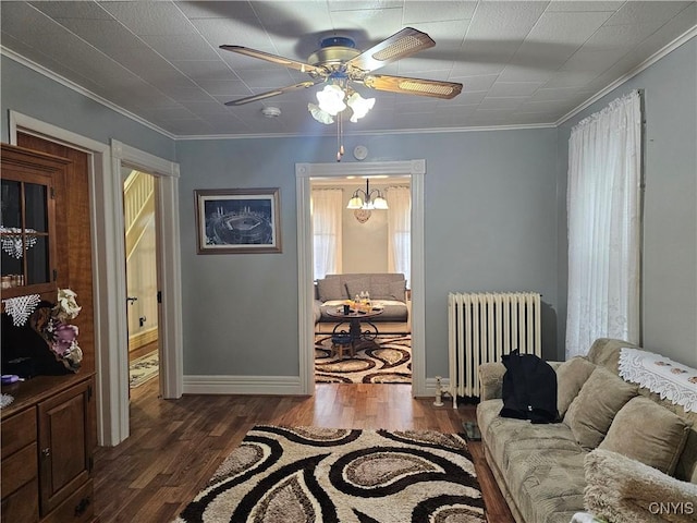 living room featuring radiator heating unit, dark hardwood / wood-style floors, and ornamental molding