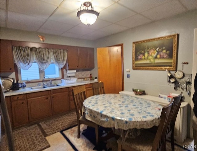 kitchen with a drop ceiling and sink