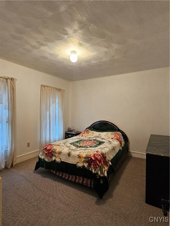 carpeted bedroom with a textured ceiling