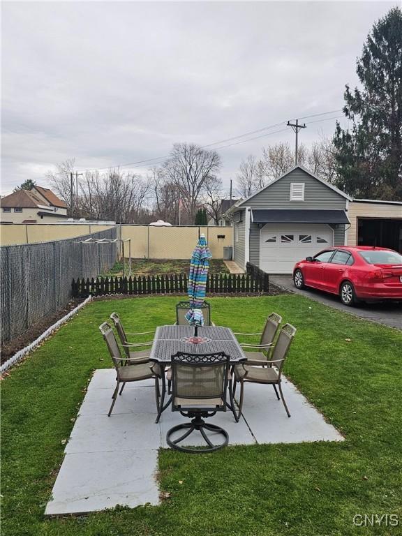 view of patio / terrace with a garage and an outdoor structure