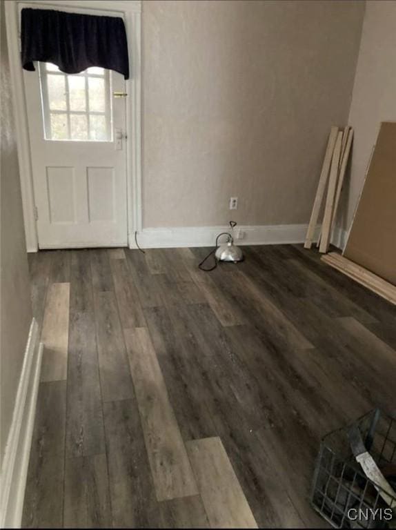 interior space with dark wood-type flooring and baseboards