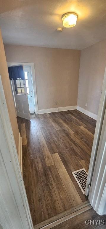 entrance foyer featuring dark wood-style floors, visible vents, and baseboards