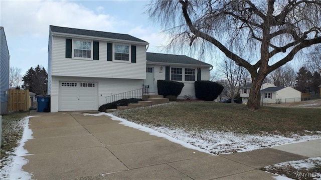 split level home with a lawn and a garage