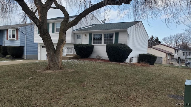 split level home featuring a front yard and a garage