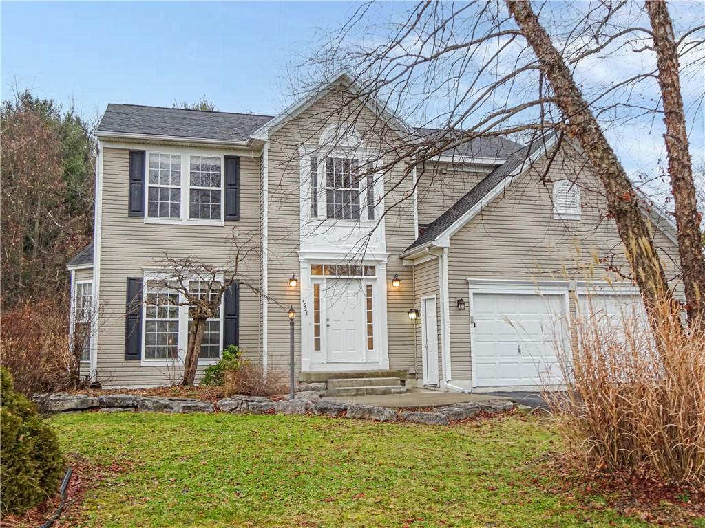 view of front of home featuring a garage and a front lawn