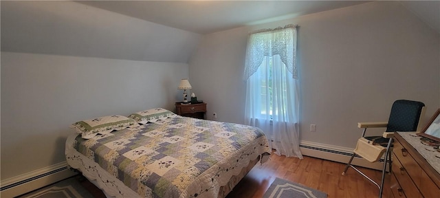 bedroom with baseboard heating, wood-type flooring, and lofted ceiling