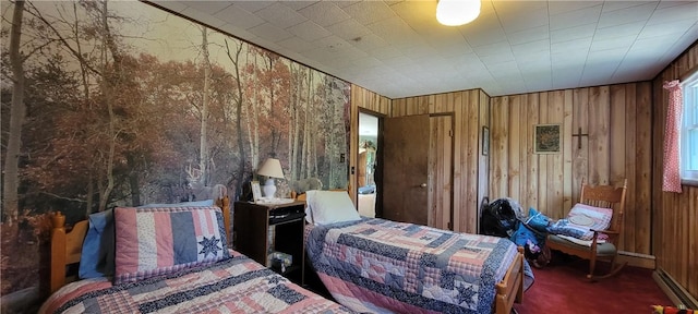 bedroom featuring wooden walls and dark colored carpet