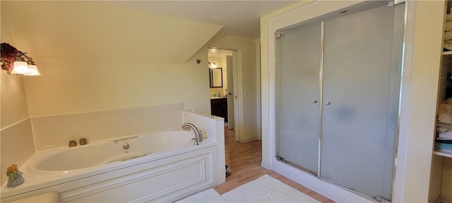 bathroom with separate shower and tub, vanity, and wood-type flooring