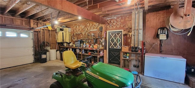 garage featuring a workshop area and fridge