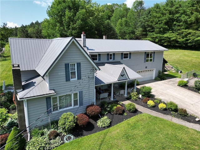 view of front of home with a garage and a front lawn