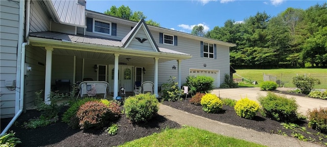 view of front of home with covered porch and a garage