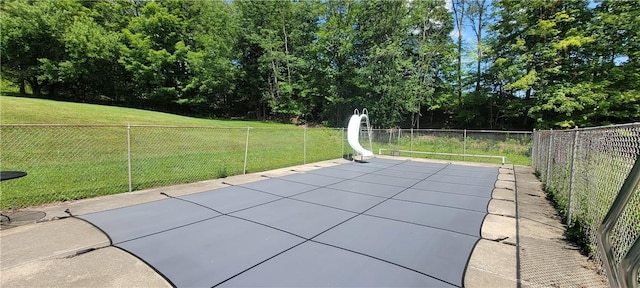 view of pool featuring a yard