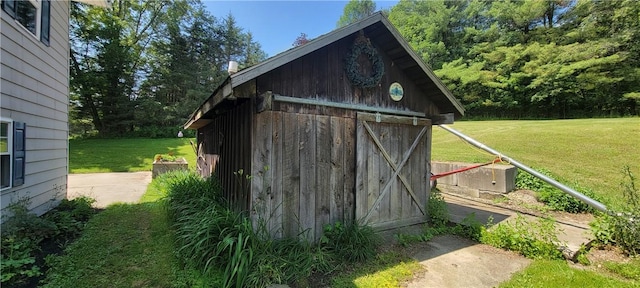 view of outdoor structure featuring a lawn