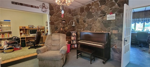 misc room with concrete flooring and a notable chandelier