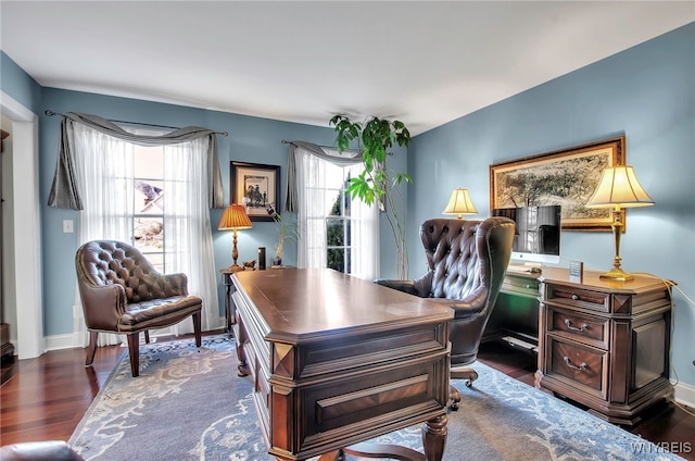 home office with dark wood-type flooring