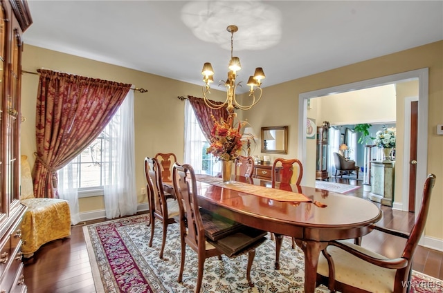 dining room featuring a chandelier and dark hardwood / wood-style floors