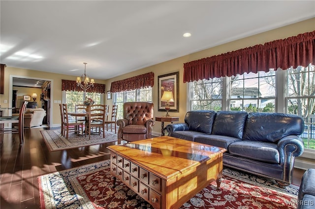 living room featuring wood-type flooring and a notable chandelier