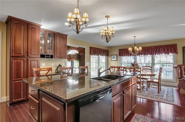 kitchen with dishwasher, dark hardwood / wood-style flooring, a center island with sink, and a healthy amount of sunlight