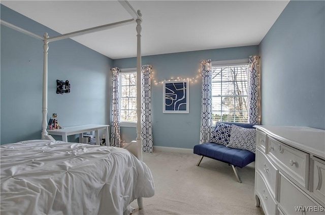 bedroom with multiple windows and light colored carpet