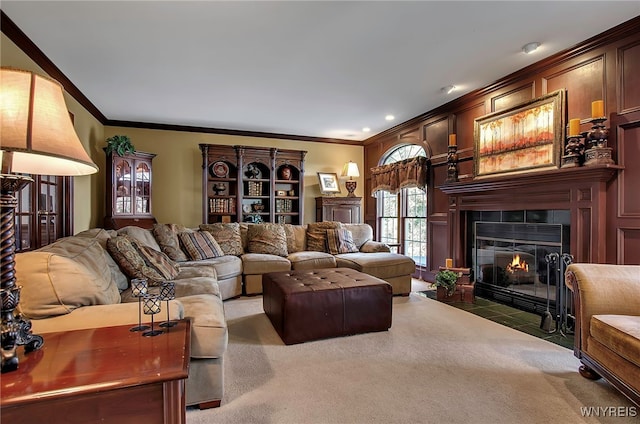 living room with a tile fireplace, light carpet, and ornamental molding