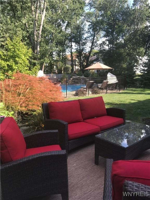 view of patio featuring a fenced in pool and an outdoor living space