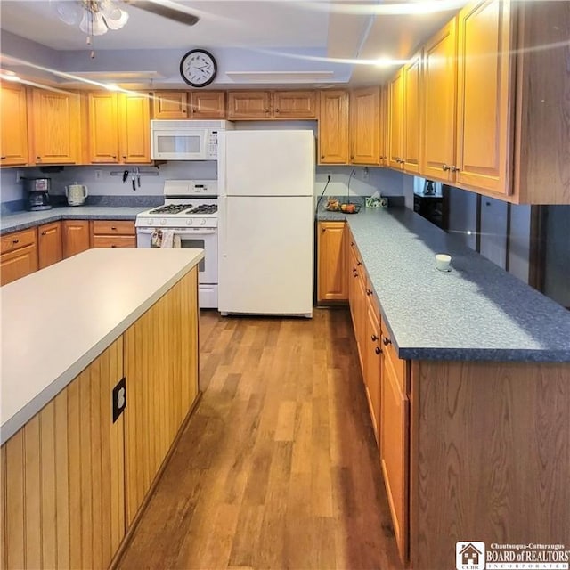 kitchen featuring ceiling fan, light wood-type flooring, and white appliances