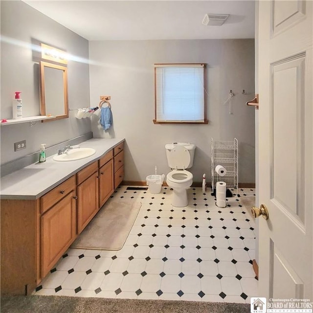 bathroom featuring vanity and toilet