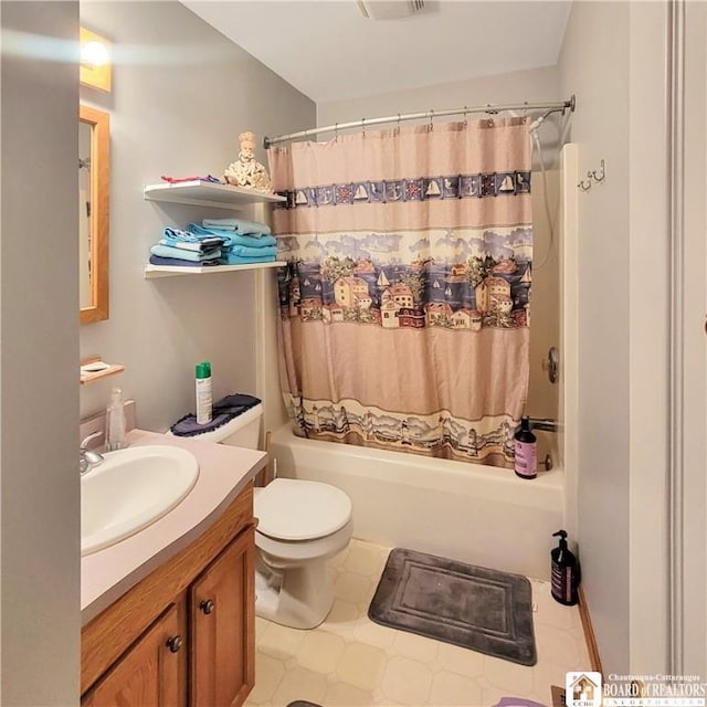 full bathroom featuring shower / bath combo with shower curtain, vanity, and toilet