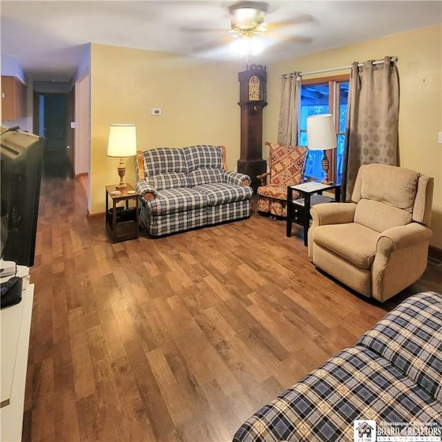 living room featuring hardwood / wood-style floors and ceiling fan