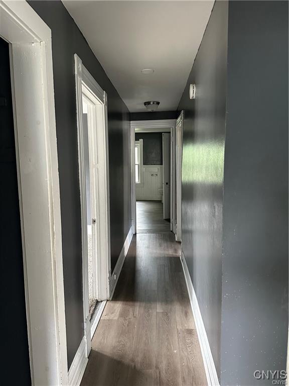 corridor featuring dark hardwood / wood-style floors and plenty of natural light