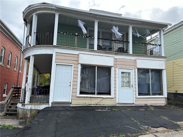 view of front of property with a porch and a balcony