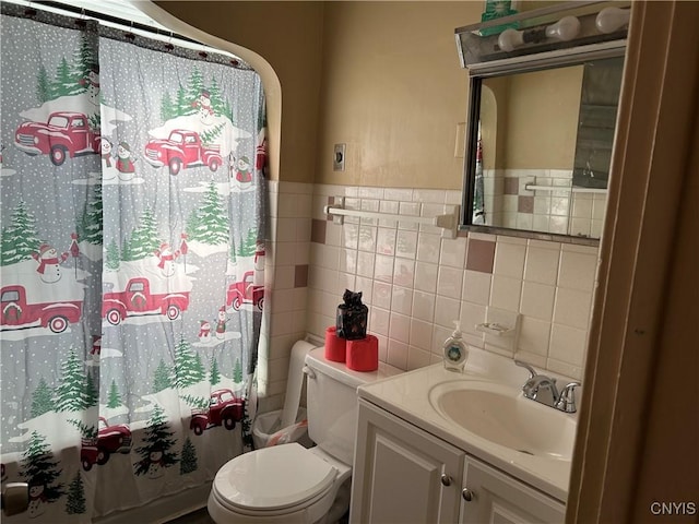 full bathroom featuring shower / tub combo with curtain, vanity, tile walls, and toilet