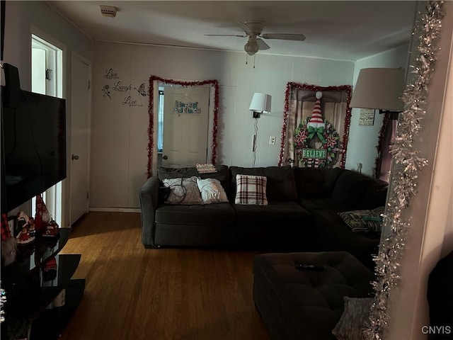 living room featuring ceiling fan and wood-type flooring