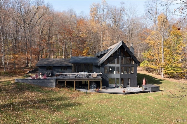 back of house featuring a deck and a lawn