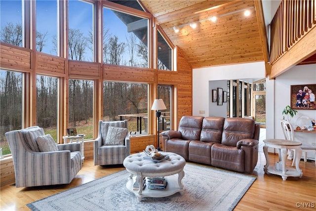 living room featuring light hardwood / wood-style flooring, high vaulted ceiling, and wood ceiling