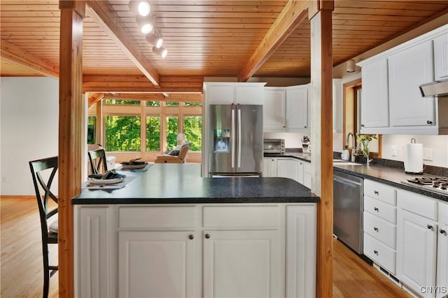 kitchen with white cabinetry, stainless steel appliances, and light hardwood / wood-style flooring