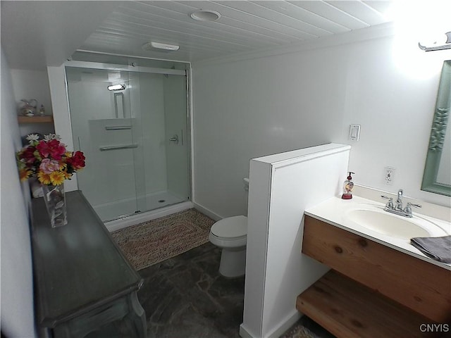 bathroom with toilet, vanity, and walk in shower