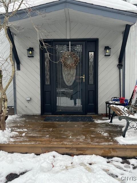 view of snow covered property entrance